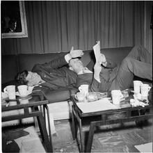 Arthur Godfrey [Godfrey and another man laying on a couch.]