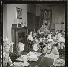 Orphanage [Children eating at tables.]