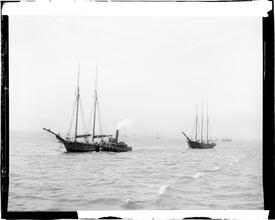 Tug towing schooner in New York Bay