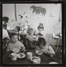 Orphanage [Children eating at tables.]