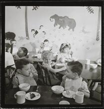 Orphanage [Children eating at tables.]
