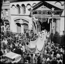 [Religious procession leaving church.]