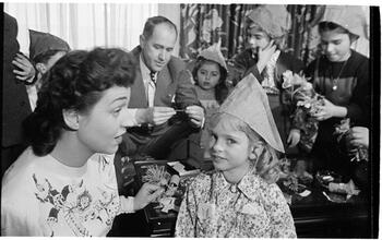 Deaf Children [Teacher putting a party hat on a child.]