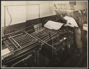 Unz & Co., Printers and Stationers, Second Floor, Man Working on Overlay at Press.