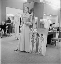 Lord & Taylor Display [A mannequin dressed in a housecoat in front of a LOOK magazine poster.]