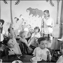Orphanage [Eating at tables.]