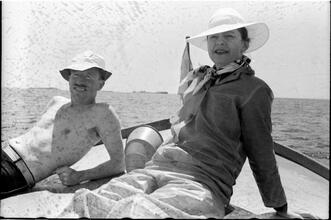 [Unidentified man and woman relaxing on boat.]