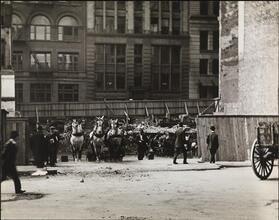 [Street scene with refuse dump and horse cart]