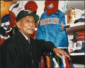 [Mayor David Dinkins posing for a photo shoot in his closet.]