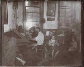 Bohemian cigar makers at work in their tenement.