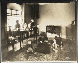 [Apartment interior, children playing with toys.]