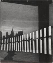 [Reflection of the skyline in the window of the ferry.]