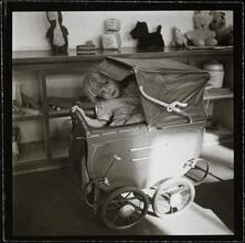 Orphanage [Girl in a baby carriage.]