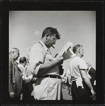 Aqueduct Race Track [Man looking at racing forms.]