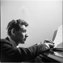 Leonard Bernstein [Leonard Bernstein at a piano.]