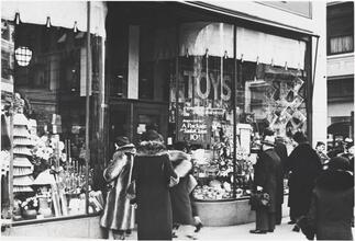 [Shoppers looking at Woolworth's window display.]