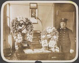 [Fireman with wreaths.]
