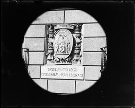 University Club seal on building wall.