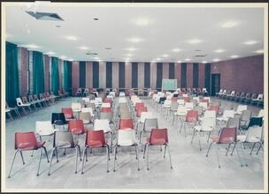 [Interior, assembly hall with chairs.]