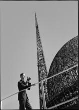 [Richard Wurts documenting the construction of the New York World's Fair site, with the frames of the Trylon and Perisphere in the background.]