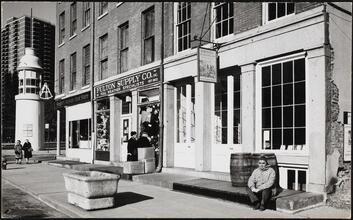 [Titanic Memorial Lighthouse and stores on Fulton Street.]