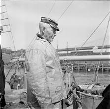 Waterfront. [Man wearing a fisherman's slicker.]
