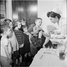 Orphanage [Nurse giving a boy a shot.]