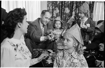 Deaf Children [Teacher putting a party hat on a child.]