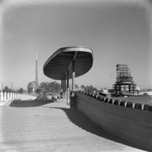 [Construction of the New York World's Fair site, with the frames of the Trylon and Perisphere in the background.]
