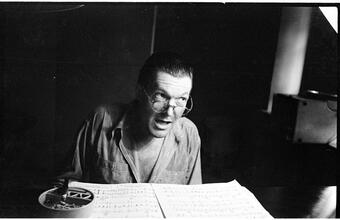 Peter Arno [Arno reading sheet music.]