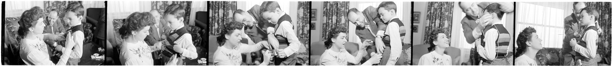 Deaf Children [Two teachers helping a child with his hearing aid.]
