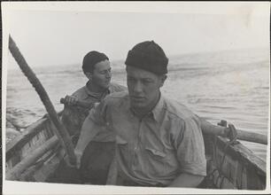 [Crew members rowing boat.]