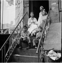 [Women and boys on stoop.]