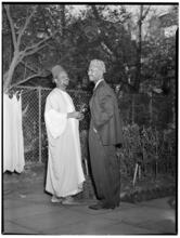 [Two men talking.]