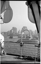 [View of waterfront activity along the Hudson River from deck of ship.]