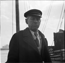 Waterfront. [Man with a mast in the background.]