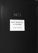[Interior, entrance to radio broadcast room.]