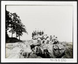 [Group portrait taken on rocks by the water.]