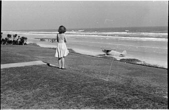 [Felicia Marsh looking at airplanes on beach.]
