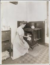 [Ethel Hassler baking bread.]