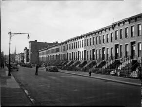 [Boy roller skating on residential street.]