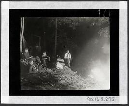 [Nightime around campfire.]