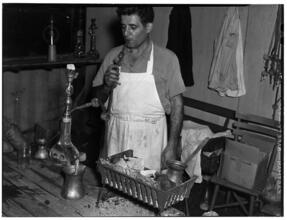 [Man smoking a hookah.]