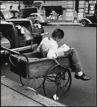 Young boy in wheel barrow, Madison Avenue between 96th and 97th Streets