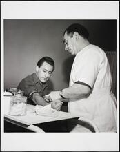 [Man having blood drawn at Ellis Island.]