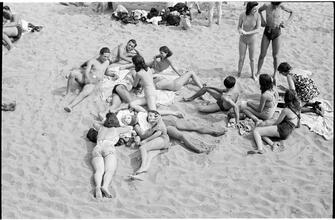 [Teenagers relaxing on Coney Island beach.]