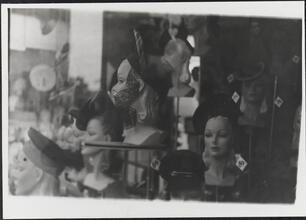 [Women's hats displayed in store window.]
