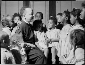 [Priest with children.]