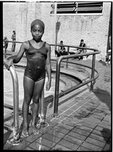 Child Standing at the Edge of Colonial Park Swimming Pool.