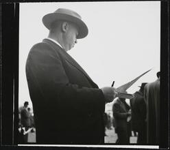 Aqueduct Race Track [Man with newspapers and racing forms at a racetrack.]